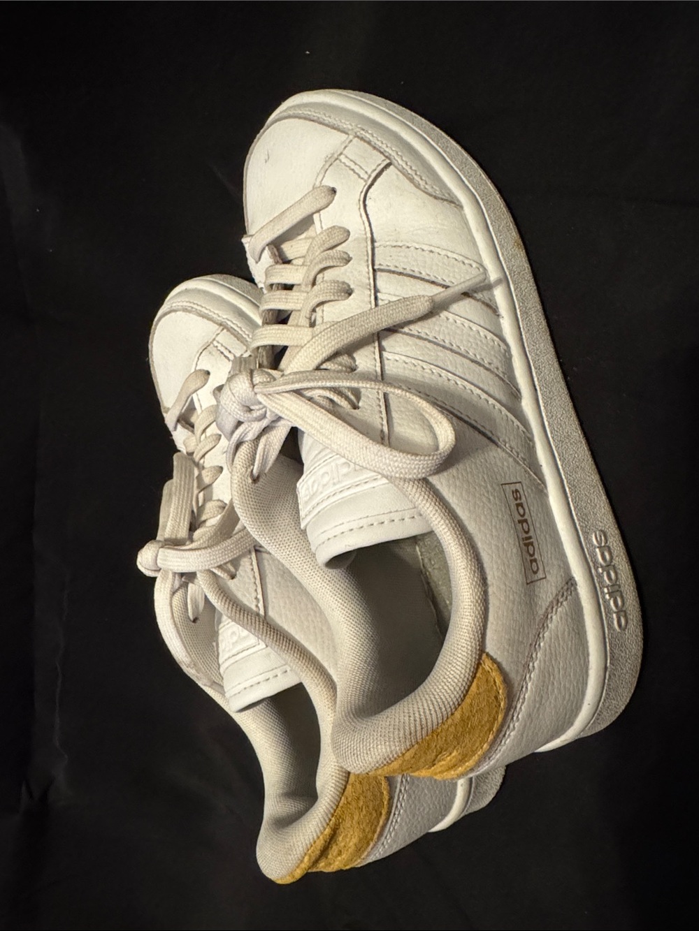 Adidas white leather sneakers with yellow heel patch